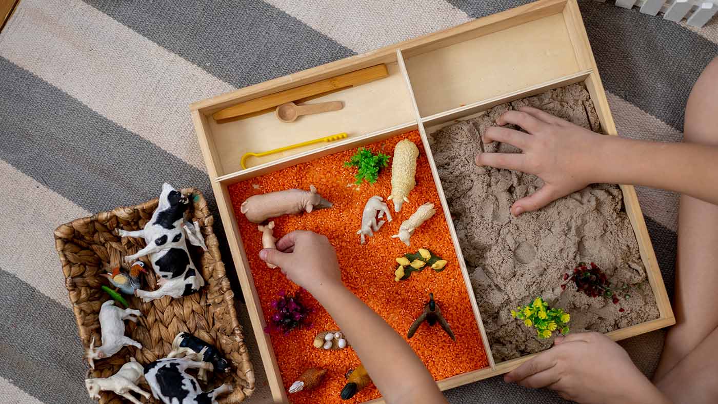 Make a tiny world to help your toddler practise moving small objects - Featured Image