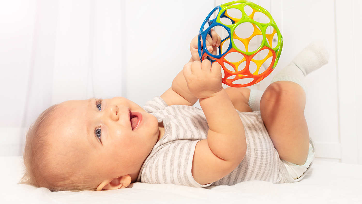 Ball games – encouraging your baby to play using both hands - Featured Image