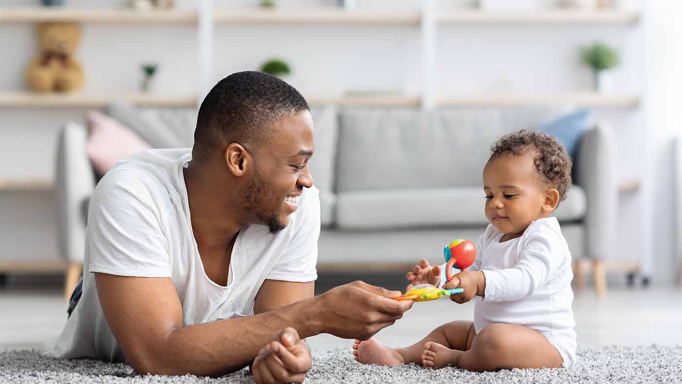 Does your baby offer a toy but then not want you to take it? It’s a fascinating part of their social development - Featured Image