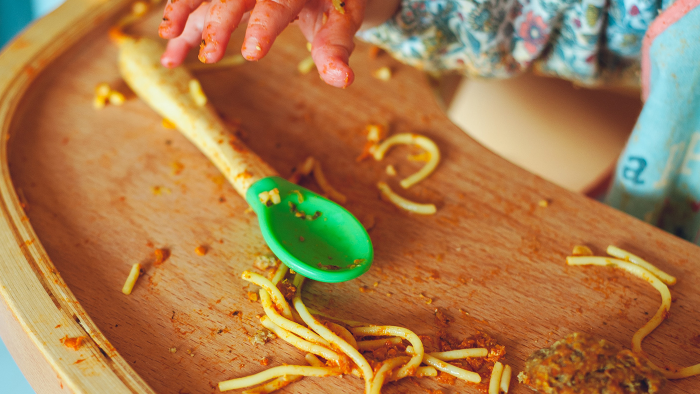 Uses their hands to move food or drink spilt on the table, watches their hands and the food as they move - Featured Image