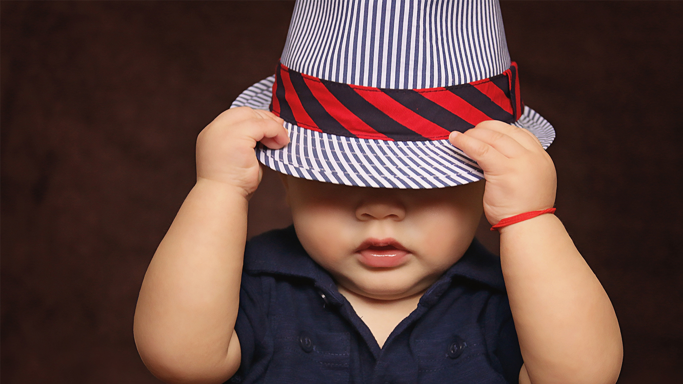 Hats off! Why your baby taking their hat off is a big thing! - Featured Image